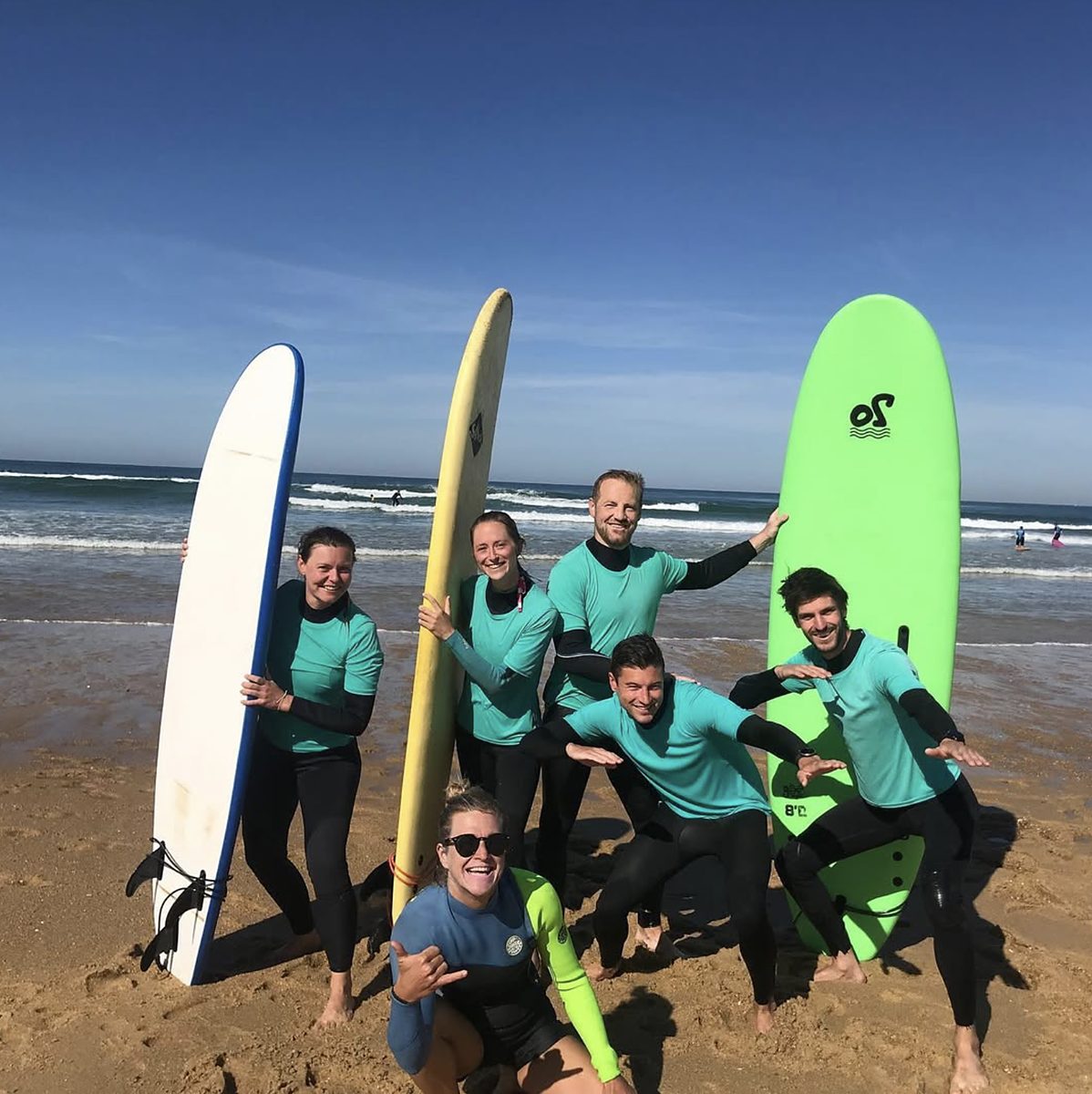 Petit groupe de surfeurs sur la plage